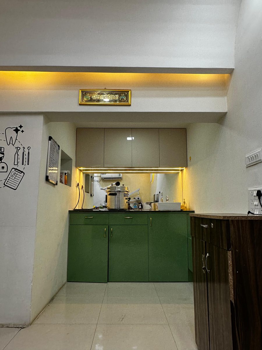 Clean, sterilised treatment counter with green cabinetry at Happy Tooth dental clinic, Mohamadwadi