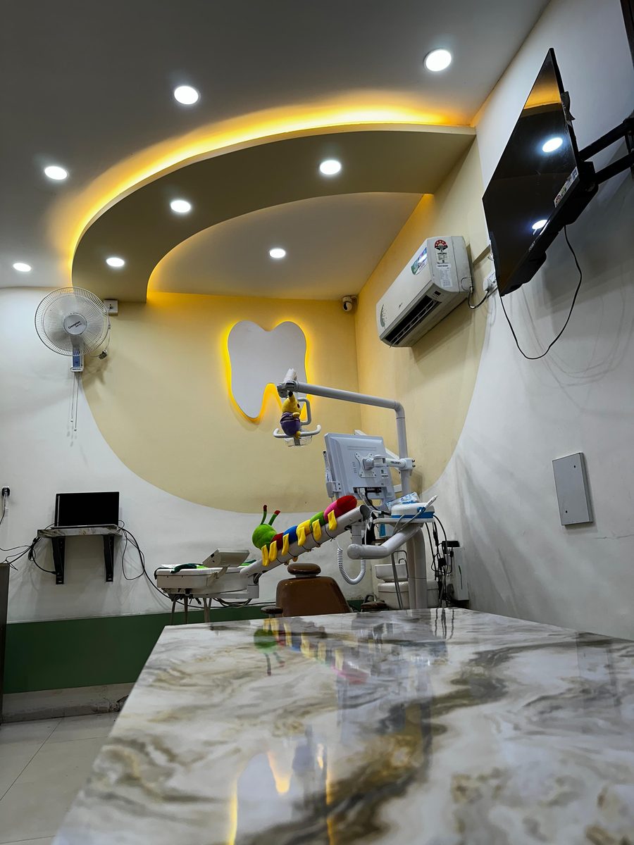 Designer treatment room with curved ceiling lighting at Happy Tooth dental clinic, Pune