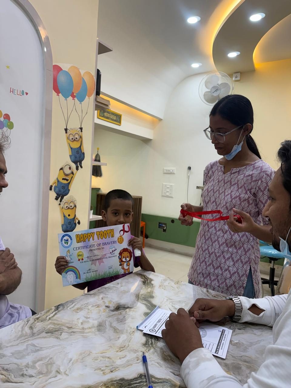 Young patients receiving Happy Tooth Certificate of Bravery awards from the team in Mohamadwadi, Pune