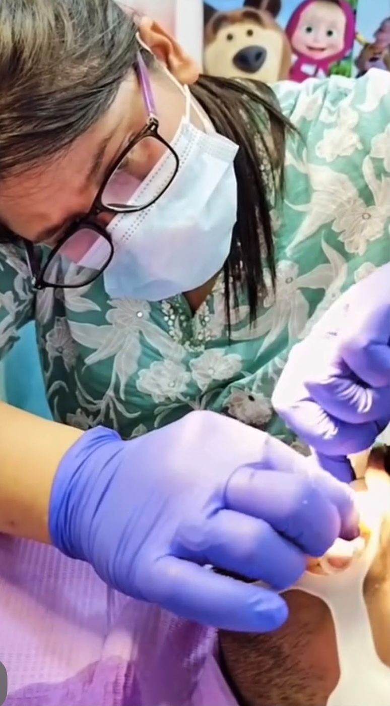 Dental specialist performing a precise clinical procedure at Happy Tooth Dental Care, Mohamadwadi, Pune