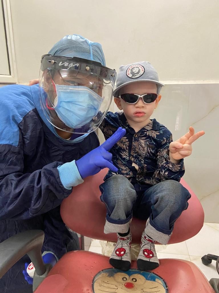 Smiling child with the pediatric dentist at Happy Tooth Children & Family Dental Care in Mohamadwadi, Pune
